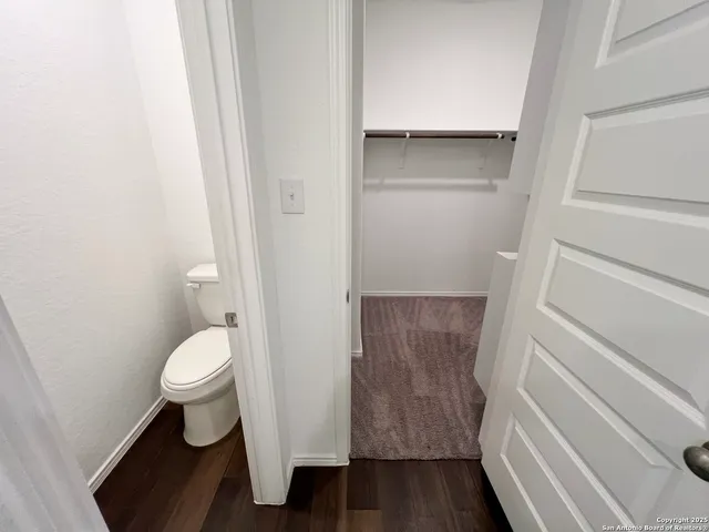 a bathroom view of a toilet and a shower