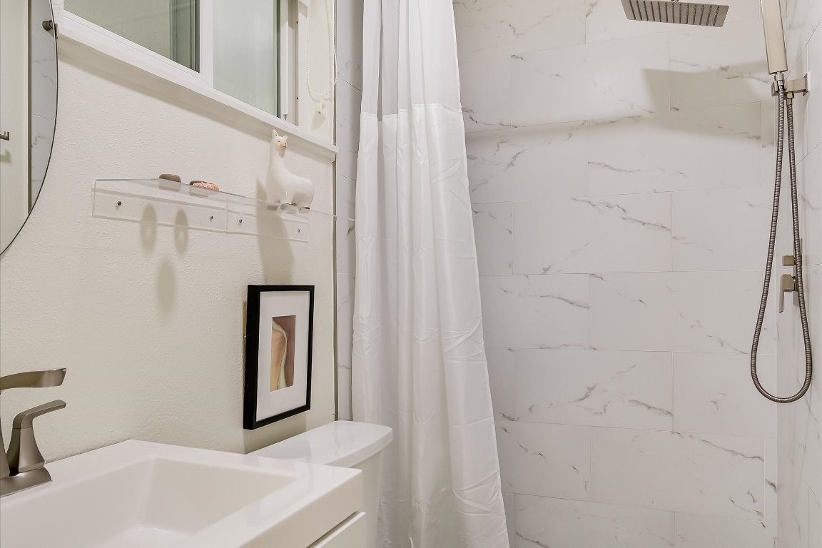 807 West Oltorf Street Austin, TX 78704 - Photo 12 of 22 Full bathroom with a marble finish shower and vanity
