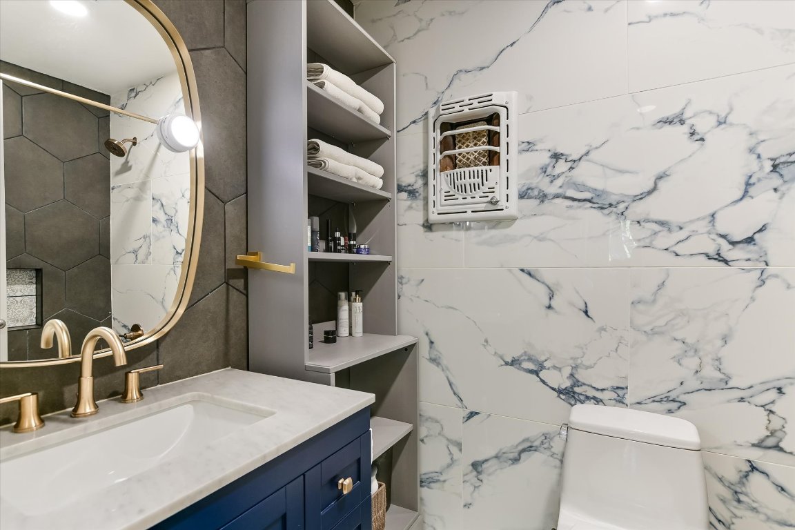 807 West Oltorf Street Austin, TX 78704 - Photo 18 of 22 Full bathroom with vanity, tile walls, and a shower