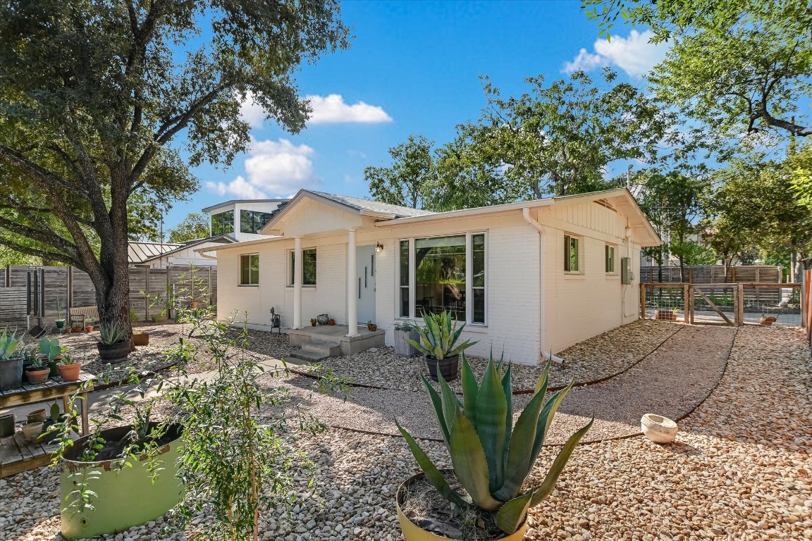807 West Oltorf Street Austin, TX 78704 - Photo 2 of 22 Rear view of property featuring brick siding, a fenced backyard, and a patio area