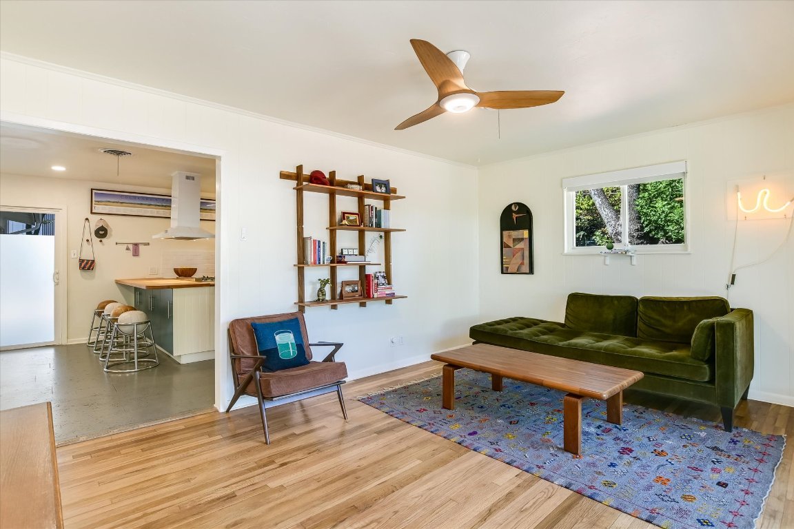 807 West Oltorf Street Austin, TX 78704 - Photo 4 of 22 Living room featuring light wood-type flooring, ceiling fan, and crown molding