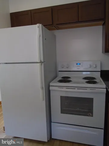 a white refrigerator freezer sitting inside of a kitchen