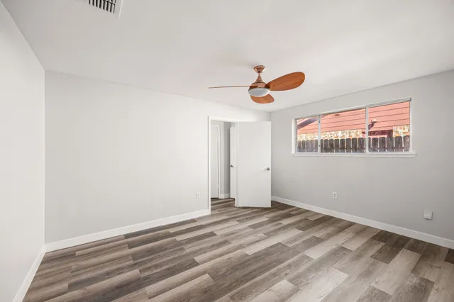 a view of a room with wooden floor and windows
