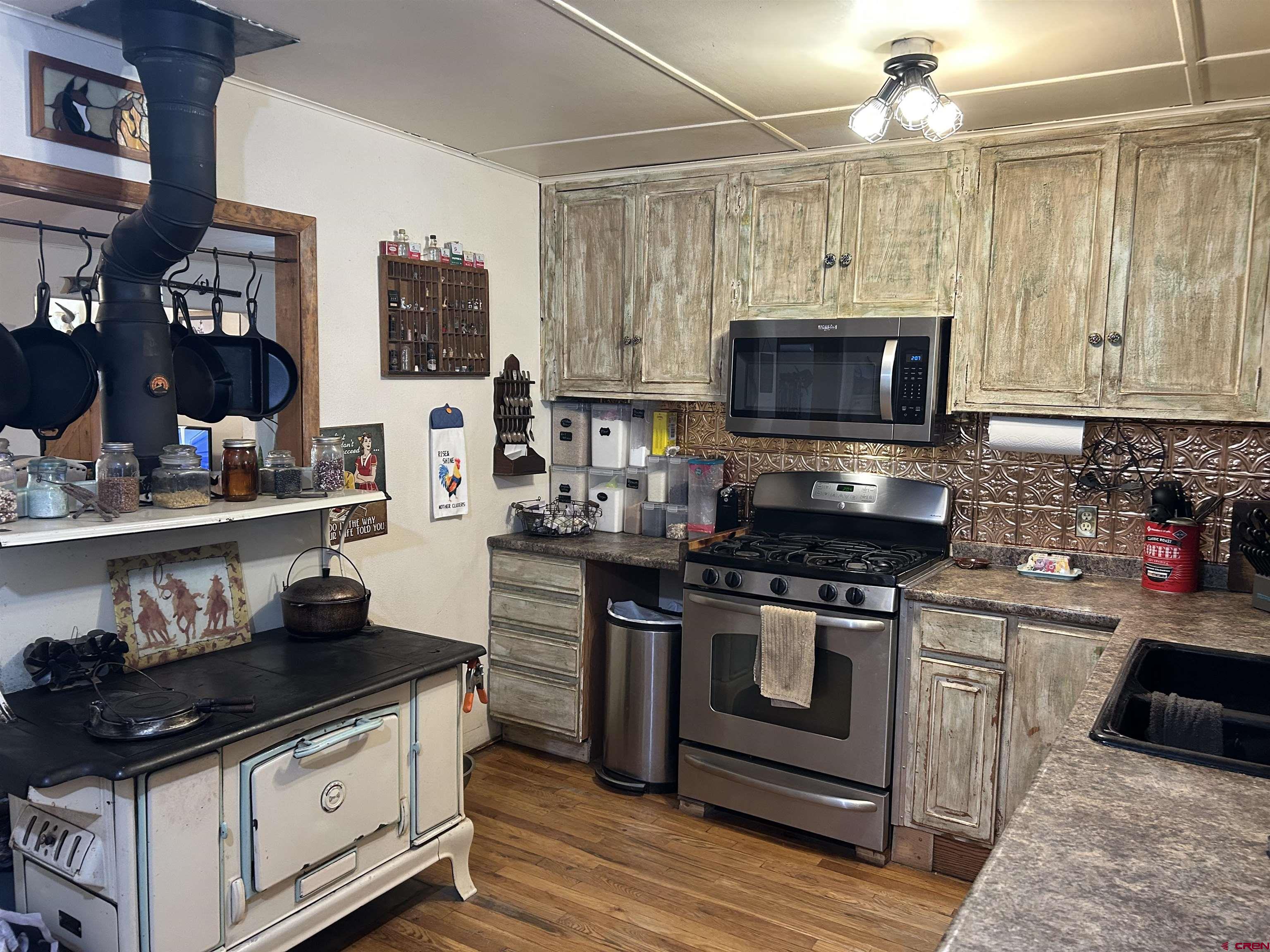27701 BB Road Nucla, CO 81424 - Photo 12 of 29 a kitchen with stainless steel appliances granite countertop a stove and a sink
