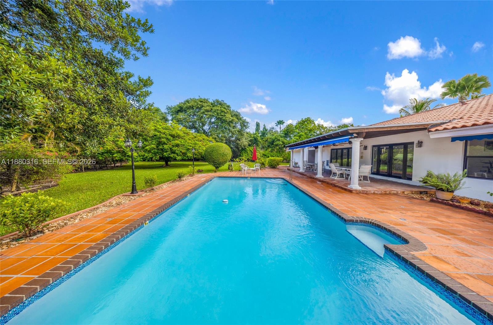 10204 Southwest 96th Court Miami, FL 33176 - Photo 1 of 54 a view of a house with swimming pool and a yard
