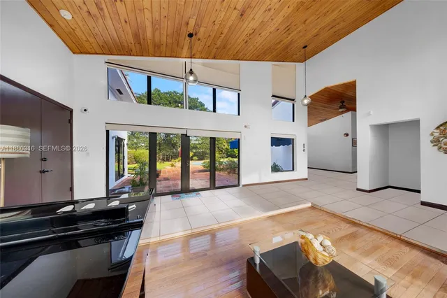 a living room with furniture and a floor to ceiling window
