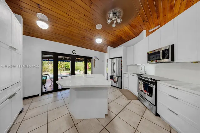 a kitchen with counter top space cabinets and stainless steel appliances