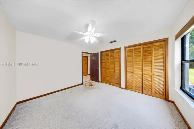 a bed room with a bed and a large window