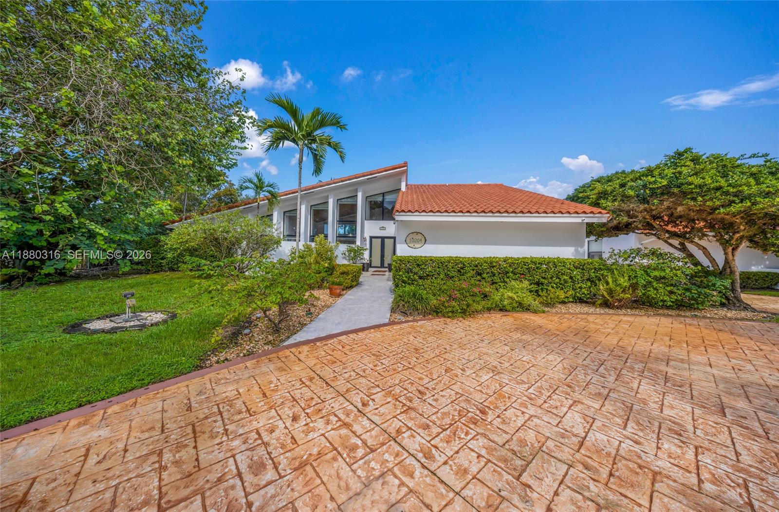 10204 Southwest 96th Court Miami, FL 33176 - Photo 3 of 54 a front view of a house with a yard