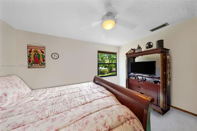 a bathroom with a sink a toilet a mirror and shower