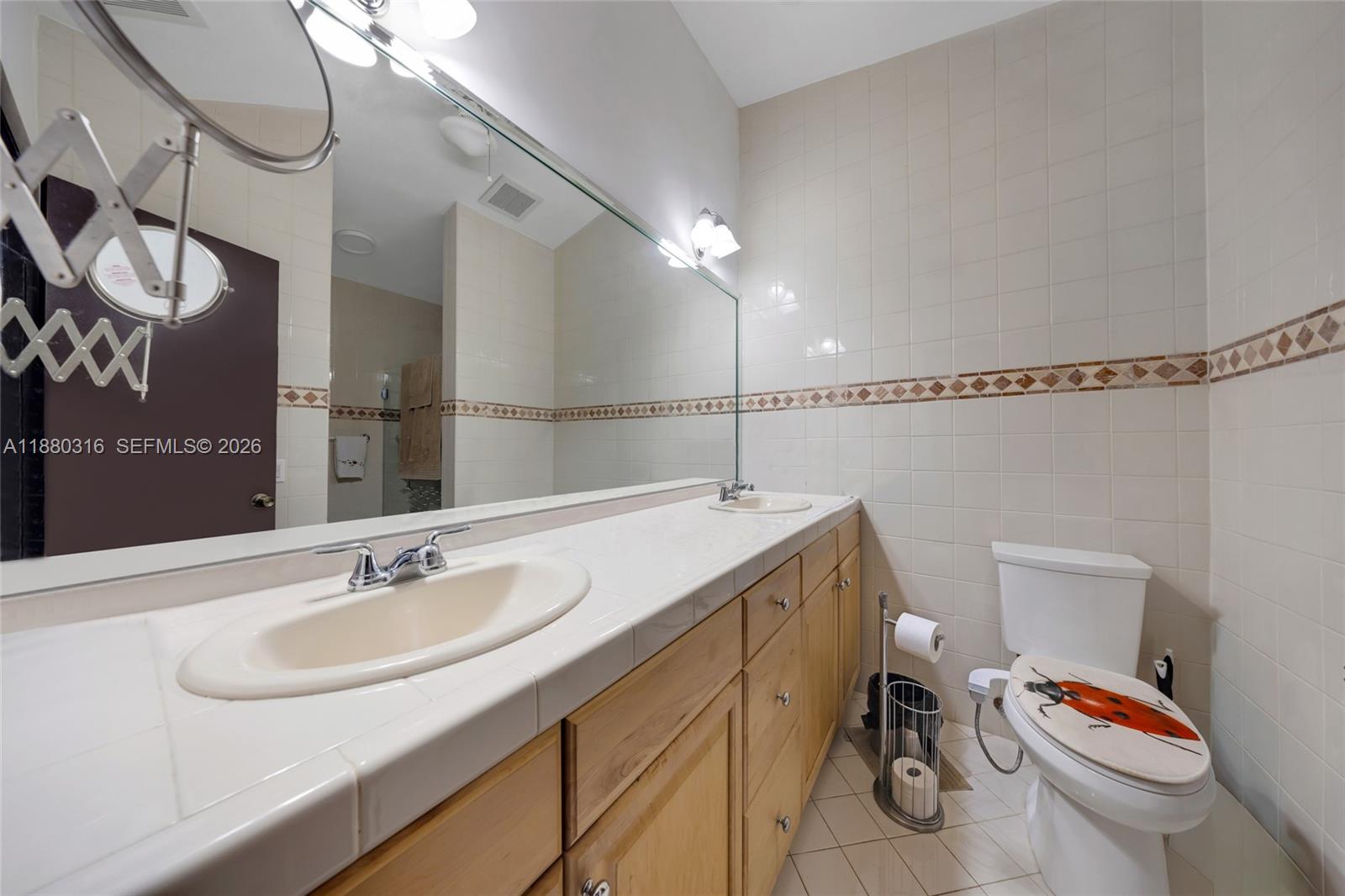 10204 Southwest 96th Court Miami, FL 33176 - Photo 33 of 54 a bathroom with a sink a toilet a mirror and shower