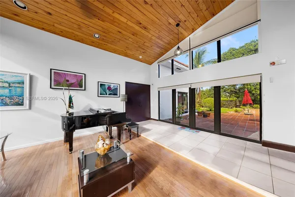 a lobby with furniture and a flat screen tv