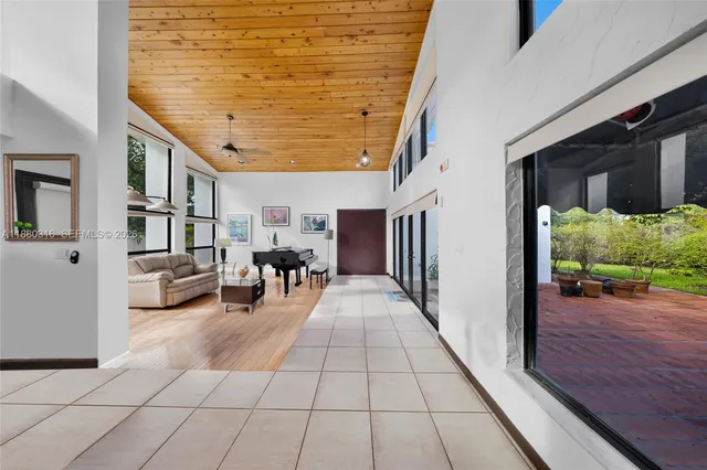 a lobby with furniture and a flat screen tv