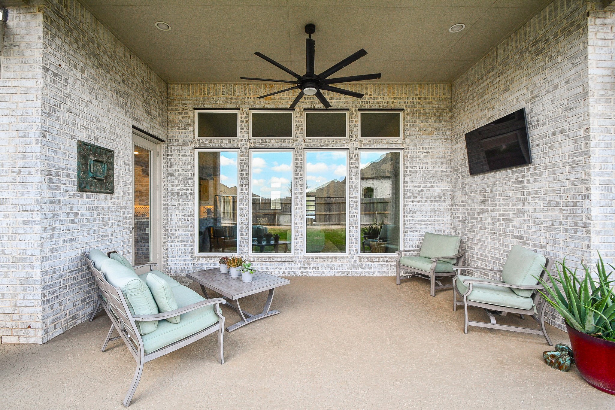 30314 Brook Point Fulshear, TX 77441 - Photo 34 of 38 Extended patio has oversized fan, tv mount, and gas hookup for grilling.