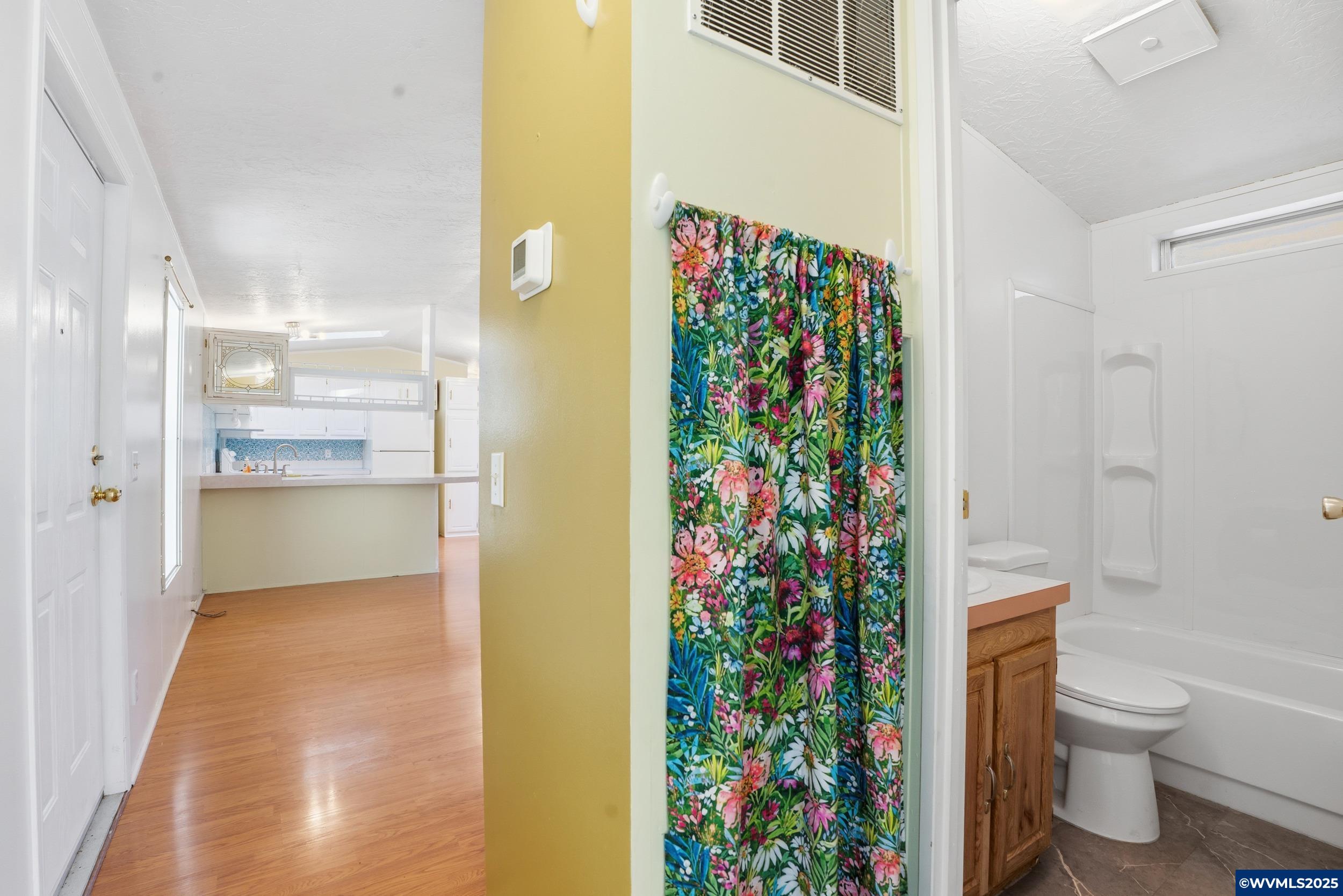 277 Edwards Road, Unit 145 Monmouth, OR 97361 - Photo 21 of 47 a bathroom with a toilet and a shower curtain