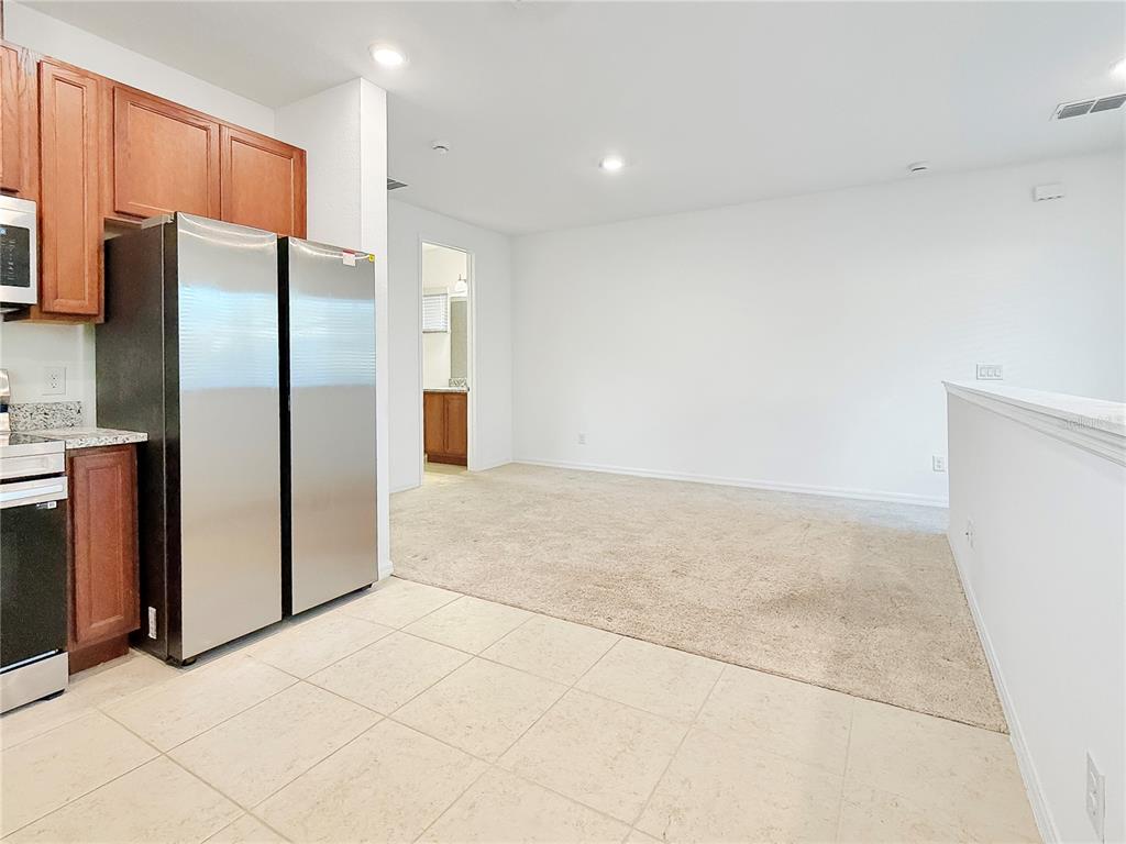 6502 Rover Way St. Cloud, FL 34771 - Photo 5 of 9 a view of a refrigerator in kitchen and an empty room