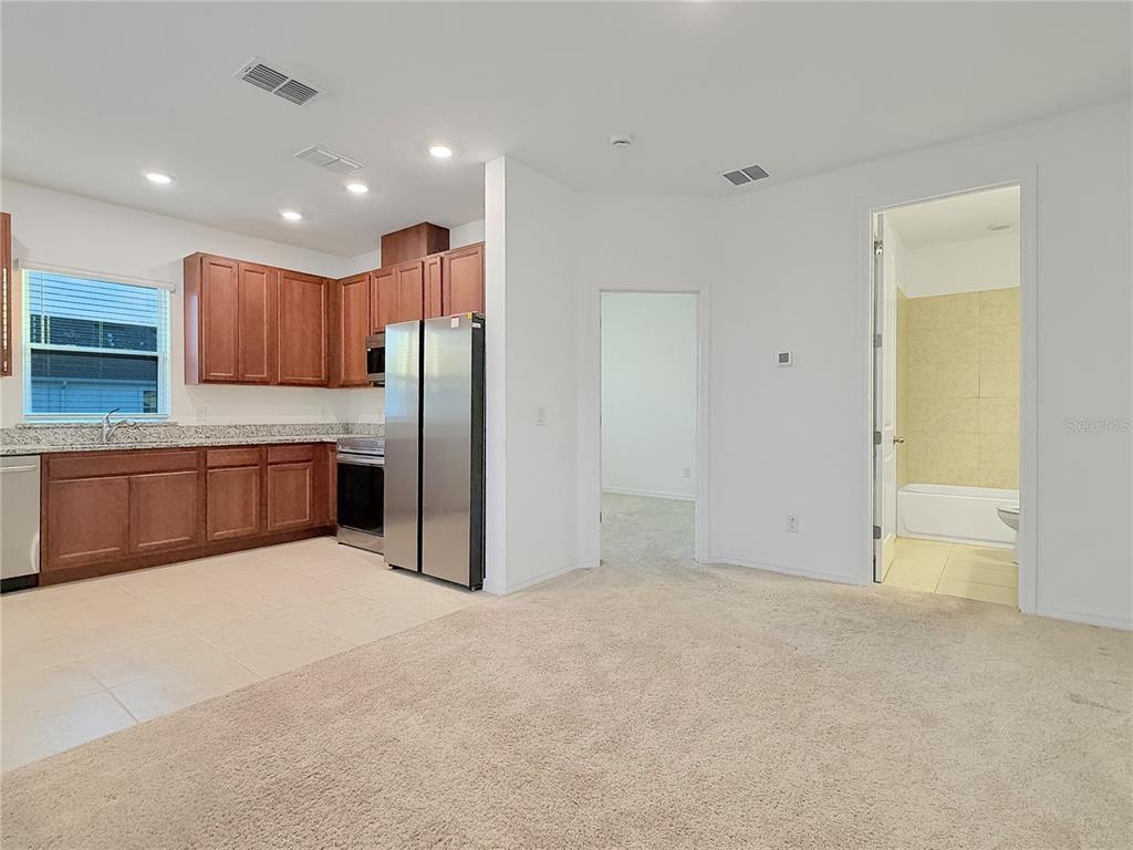 6502 Rover Way St. Cloud, FL 34771 - Photo 6 of 9 a kitchen with stainless steel appliances a refrigerator and wooden cabinets