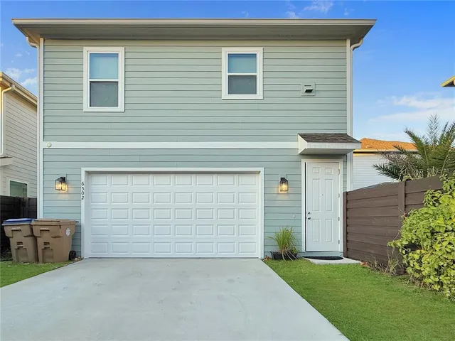 a couple of potted plants in front of door