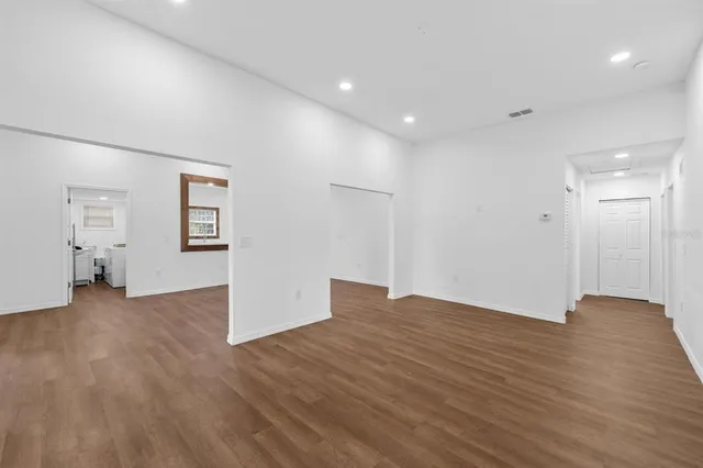 a view of empty room with wooden floor