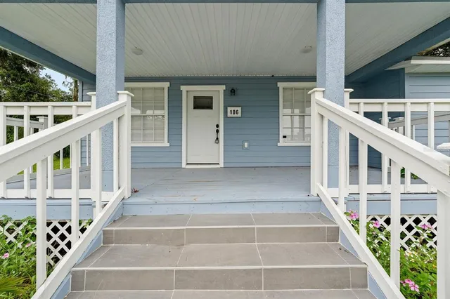 a view of wooden house with large windows