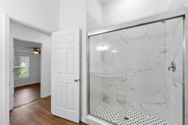 a bathroom with a glass shower door