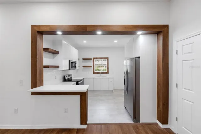 a room with a sink and a refrigerator