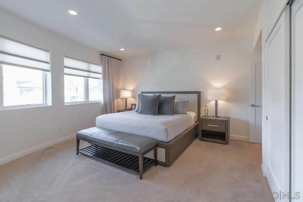 6767 Neptune Place, Unit 301 La Jolla, CA 92037 - Photo 11 of 39 a bedroom with a bed and window