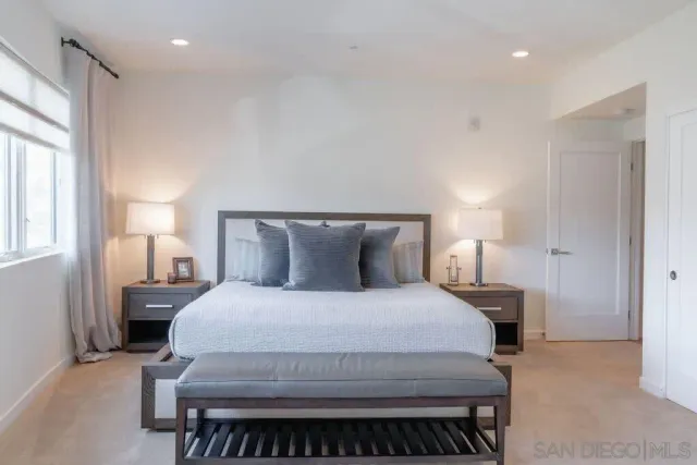 a bedroom with a bed and a night stand