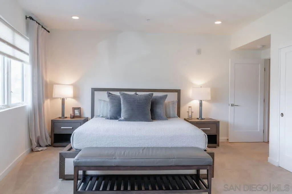6767 Neptune Place, Unit 301 La Jolla, CA 92037 - Photo 12 of 39 a bedroom with a bed and a night stand