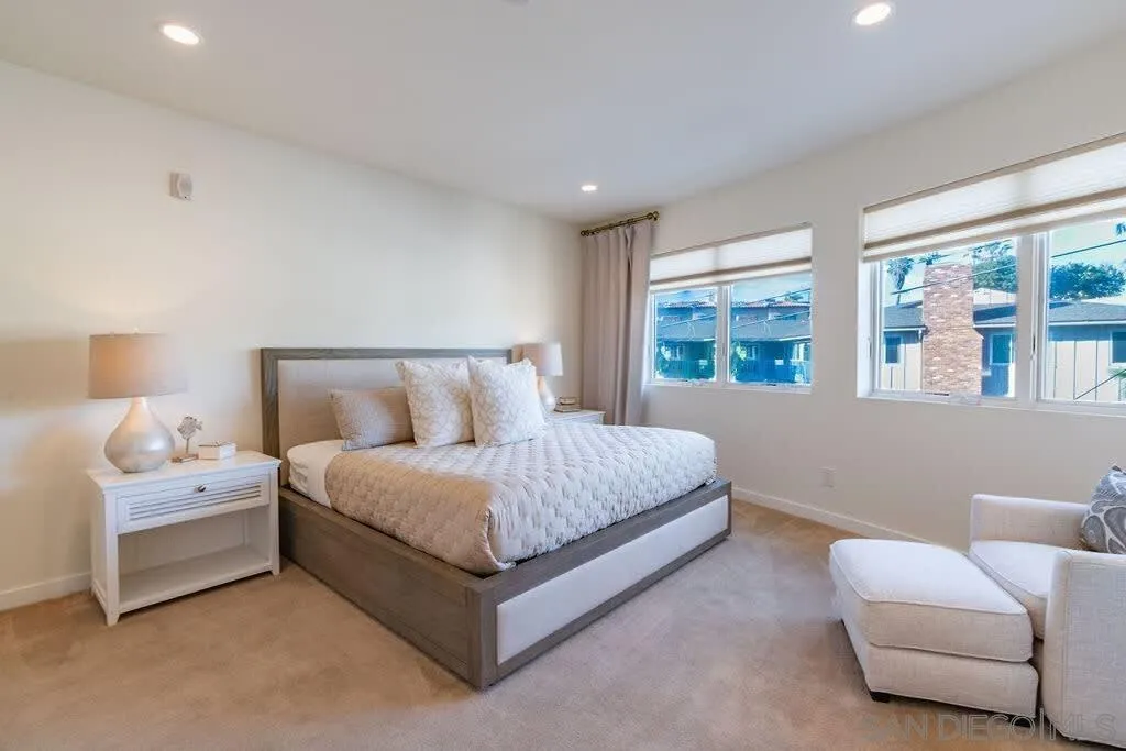 6767 Neptune Place, Unit 301 La Jolla, CA 92037 - Photo 15 of 39 a spacious bedroom with a bed and a couch