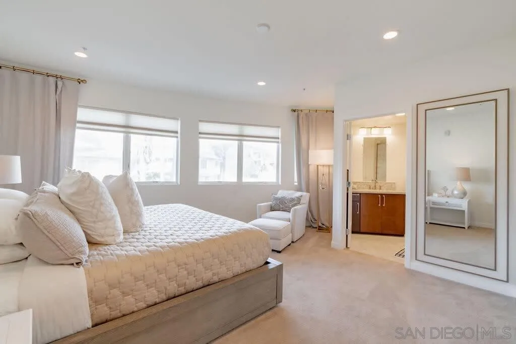 6767 Neptune Place, Unit 301 La Jolla, CA 92037 - Photo 16 of 39 a bedroom with a bed and a large window