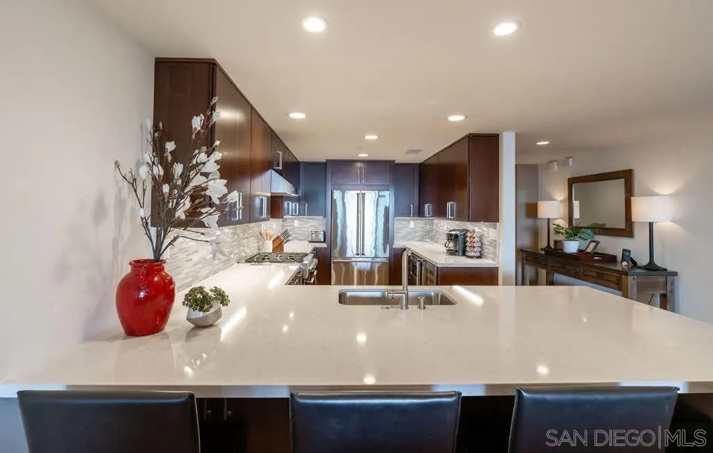 6767 Neptune Place, Unit 301 La Jolla, CA 92037 - Photo 20 of 39 a view of kitchen with stainless steel appliances granite countertop sink