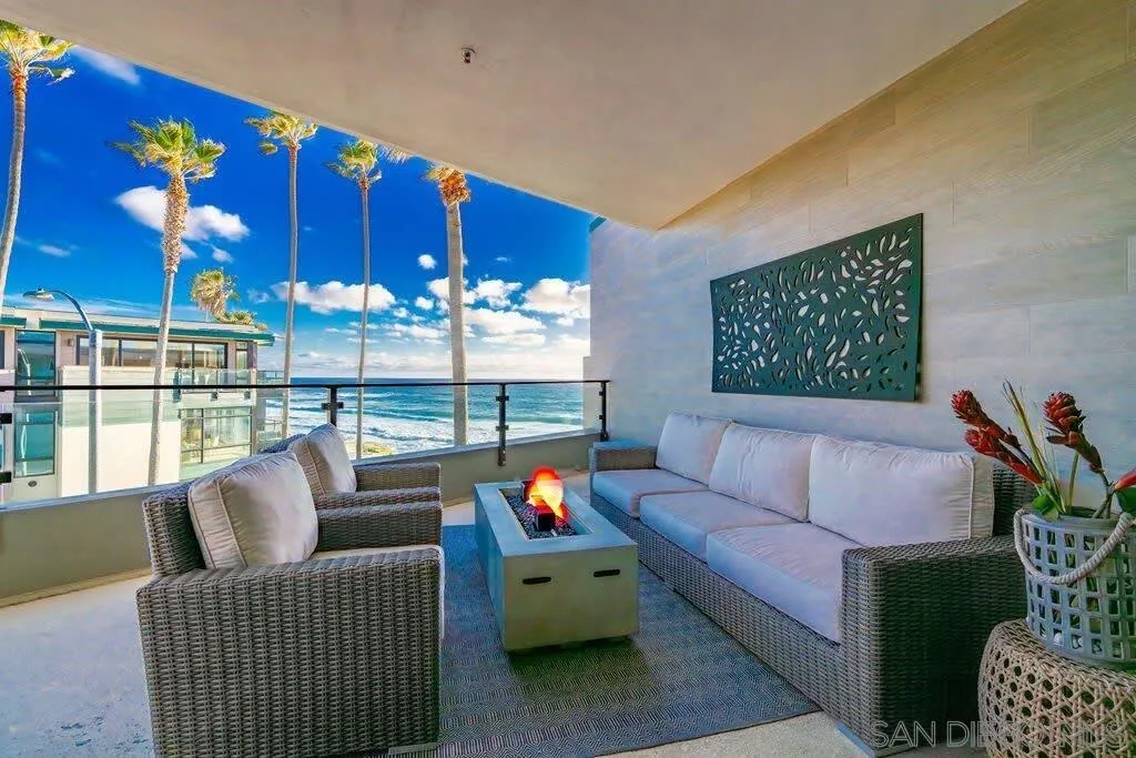 6767 Neptune Place, Unit 301 La Jolla, CA 92037 - Photo 30 of 39 a living room with furniture and a floor to ceiling window