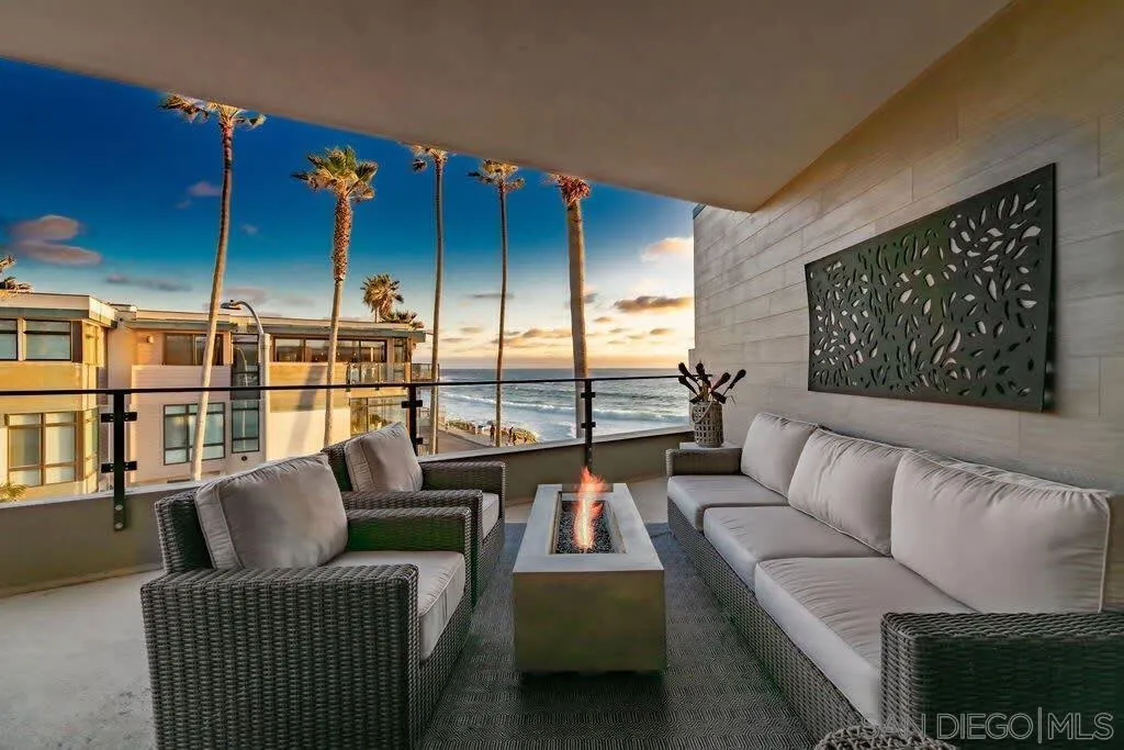 6767 Neptune Place, Unit 301 La Jolla, CA 92037 - Photo 3 of 39 a living room with furniture a rug and a floor to ceiling window