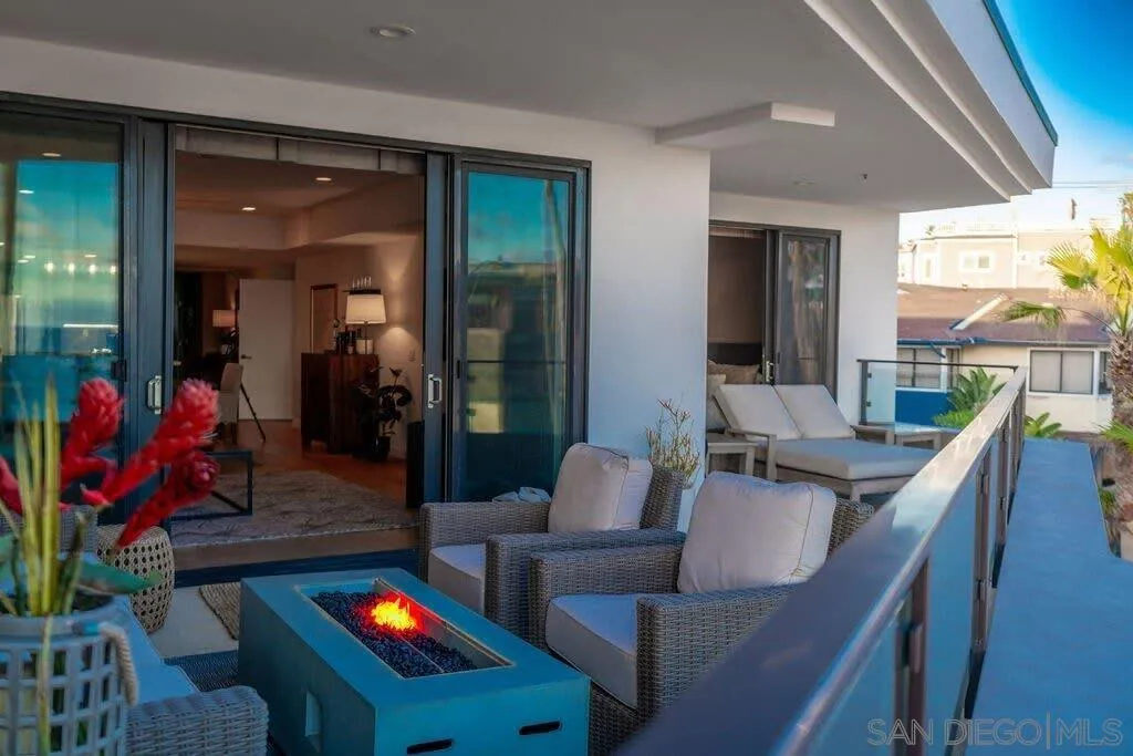 6767 Neptune Place, Unit 301 La Jolla, CA 92037 - Photo 37 of 39 a living room with furniture and a floor to ceiling window