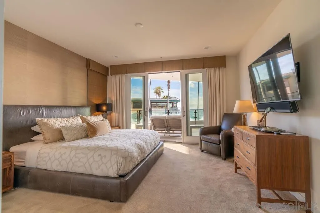 6767 Neptune Place, Unit 301 La Jolla, CA 92037 - Photo 5 of 39 a bedroom with bed couch and window