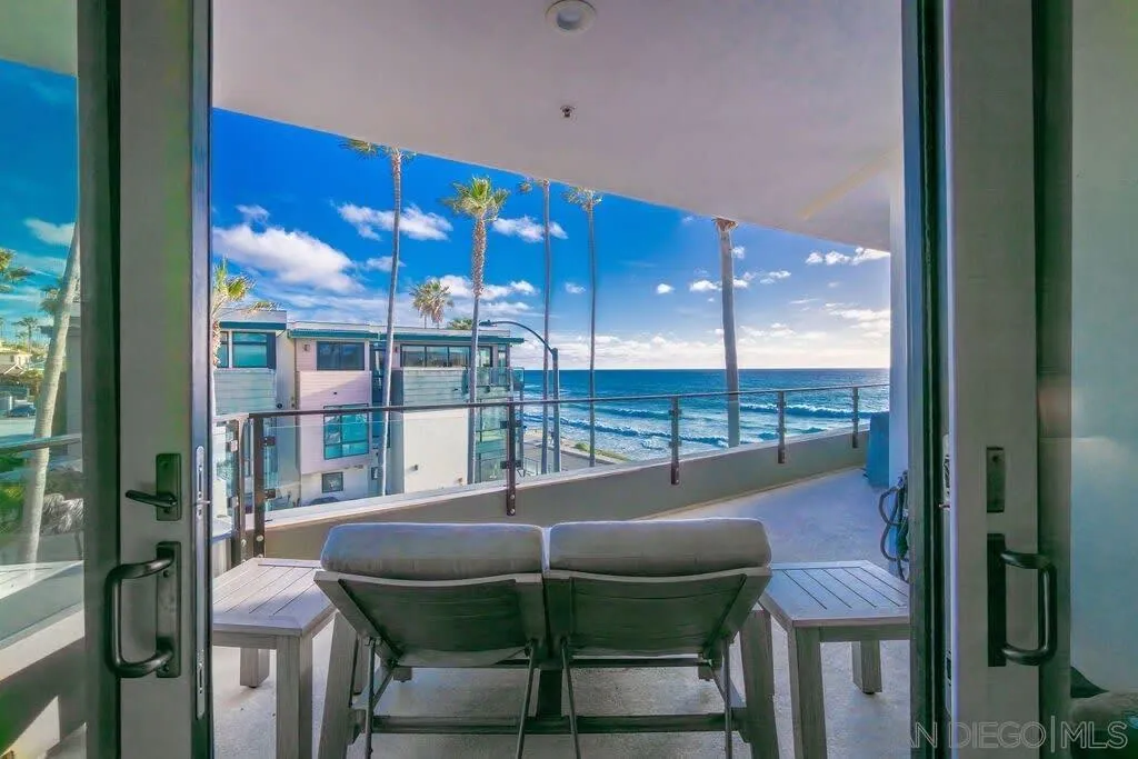 6767 Neptune Place, Unit 301 La Jolla, CA 92037 - Photo 7 of 39 a dining room with furniture and a floor to ceiling window