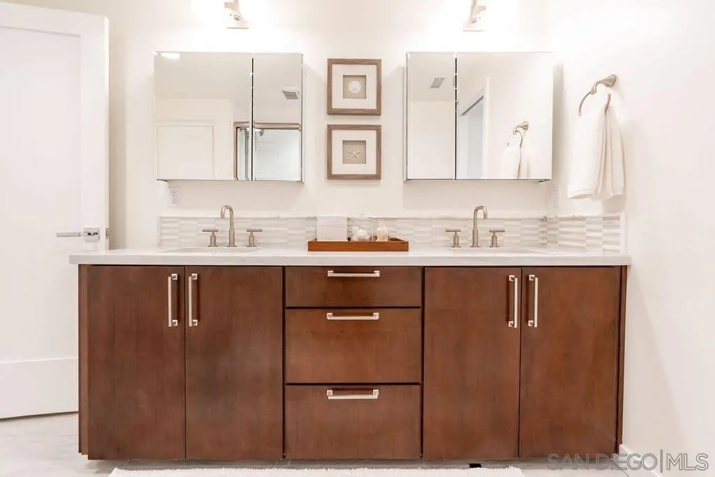 6767 Neptune Place, Unit 301 La Jolla, CA 92037 - Photo 9 of 39 a bathroom with a sink and a mirror