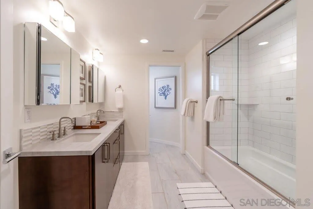 6767 Neptune Place, Unit 301 La Jolla, CA 92037 - Photo 10 of 39 a bathroom with a sink and a mirror
