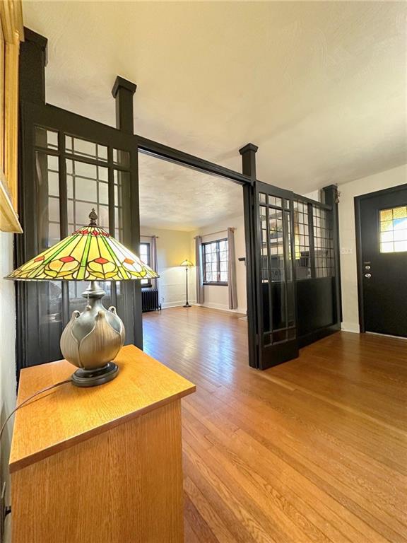 5515 Richland Road Gibsonia, PA 15044 - Photo 8 of 46 Classic Cape Cod Architecture commands an Entry which is open to the Living Room; a brilliant owner added this Architecturally pleasing divider to avoid a change of temperature while keeping the volume of the spaces. The double doors are shown open here, and this view of the Entry looks toward the front door.