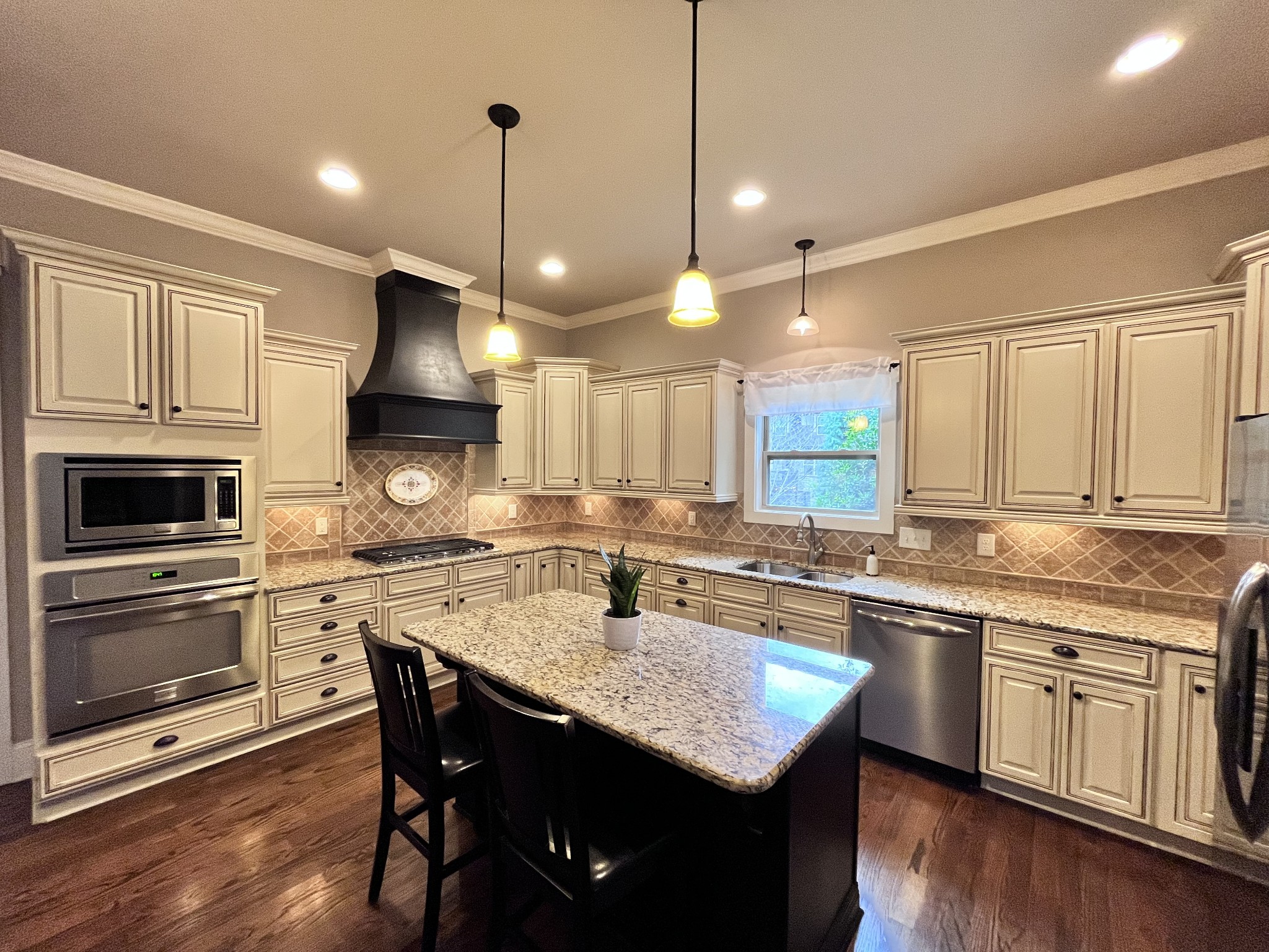2667 Sporting Hill Bridge Road Thompson's Station, TN 37179 - Photo 9 of 42 a kitchen with a stove sink cabinets and wooden floor