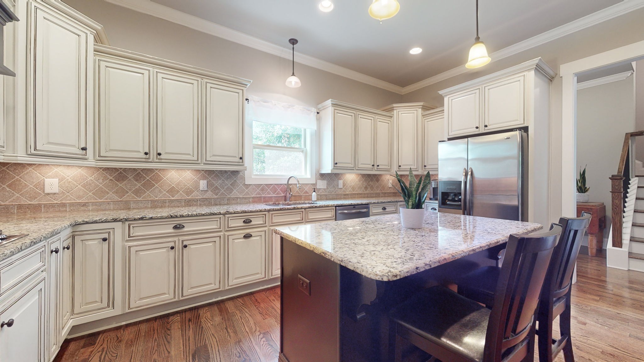 2667 Sporting Hill Bridge Road Thompson's Station, TN 37179 - Photo 10 of 42 a kitchen with center island white cabinets and stainless steel appliances