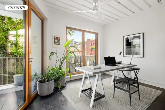 a bedroom with a large bed and a large window