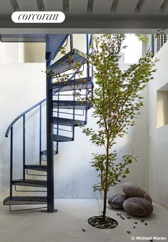 a building outdoor space with patio furniture and potted plants