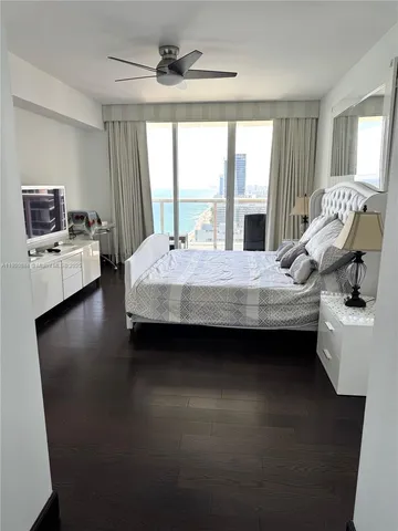 a bedroom with a bed window and table