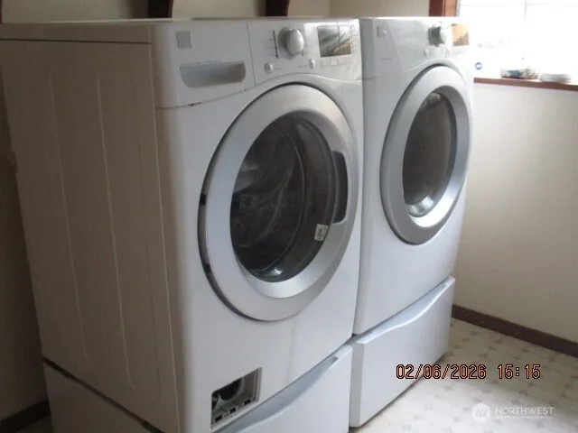 a white house with green field in front of it