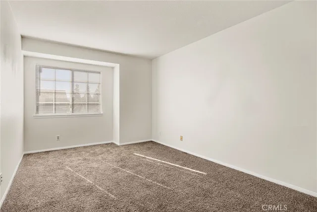 a view of an empty room and closet area