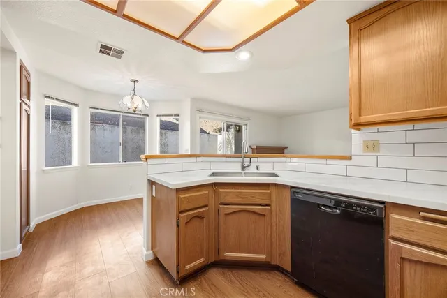a kitchen with a sink cabinets and wooden floor