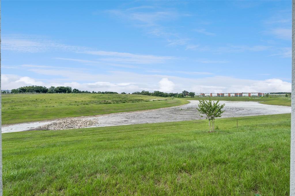 1672 Rider Rain Lane Apopka, FL 32703 - Photo 33 of 35 a view of a lake with a big yard