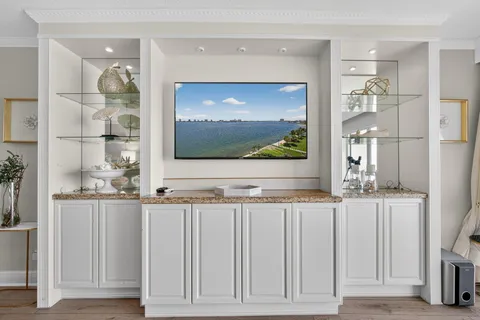 a view of living room with a flat screen tv and floor to ceiling window